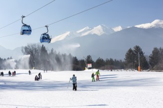Bansko, Bulgaria, February 11, 2023: Bulgarian winter ski resort panorama with gondola lift cabins,