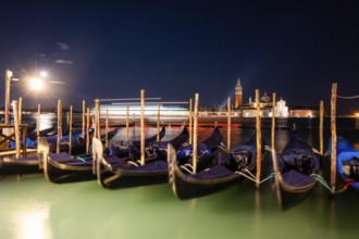 Venetian gondolas, boat mooring at St Mark's Square, church of San Giorgio Maggiore in the