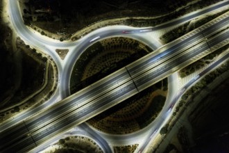 Aerial drone top view of a modern designed motorway junction. roundabout with cars moving. Cars