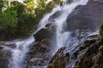 Water splashing through the rocks and forest forming a beautiful waterfall in Minas Gerais, Brazil,