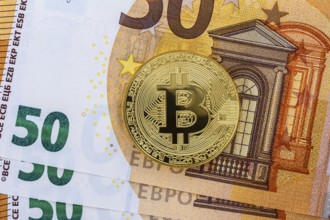 Bitcoin coin on euro banknotes as background