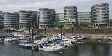 A harbour with several boats in front of modern, round buildings, Duisburg, North Rhine-Westphalia,