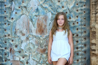 Kid girl tourist in Mediterranean old town door at Spain