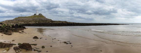 A panorama view of the Mumbles headland with the historic lighthouse in Swansea Bay