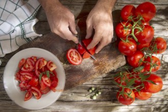 Cut and prepare preserves for the winter with smooth round tomato