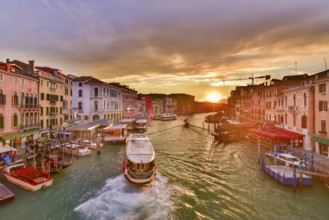 The Grand Canal with gondola and vaporetto at sunset time, Venice, Italy, Europe