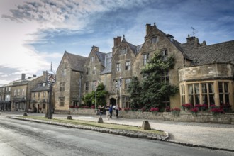 Broadway, UK, August 12, 2015: Main street of Broadway with typical limestone buildings with the