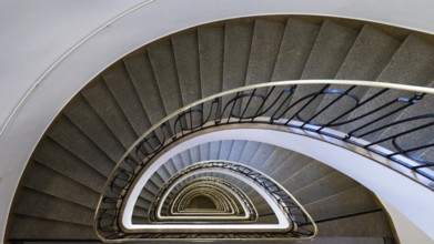 A spiral staircase with metal railings that displays impressive symmetry in the Altstadt-Lehe