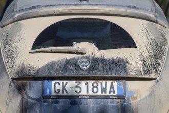 Dirty car with dusty rear end and Italian licence plate, Asciano, Province of Siena, Tuscany,
