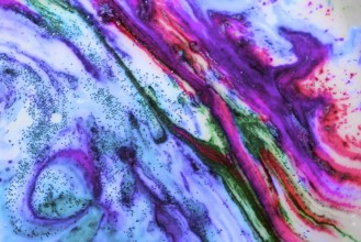 Multicoloured background of bright colours covered with gold sparkles
