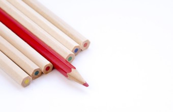 Color art pencils with sharpened red pencil on a white background