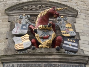 Stone relief with a red unicorn and several colourful coats of arms, hoorn, ijsselmeer, netherlands