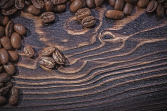 Roasted natural coffee beans on vintage wooden board