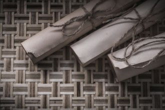 Vintage rolled scrolls on woven wooden mat