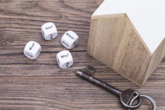 The photo shows a model house with various question cubes and a key