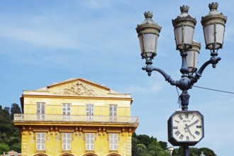 Street lamp with clock in front of the