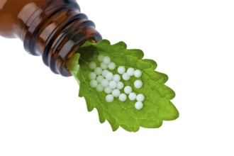 Homeopathy. Globules as an alternative medicine. Lying on a sheet, Homeopathy. Globules as