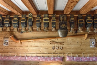 Cow bells displayed in restaurant of mountain farm. Vosges, Alsace, France, Europe
