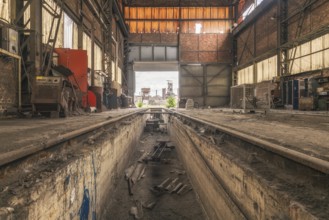 Old abandoned workshop with rails in the centre, numerous tools and rusty walls, steelworks HF4,