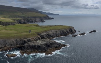 Aerial view of the rugged coastline of County Donegal at Malin Beg with the ruins of the Napoleonic