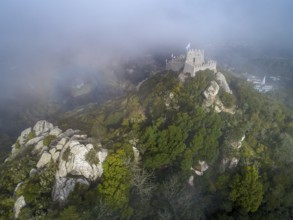 Aerial view of Castelo dos Mouros or Moorish Castle in fog, Sintra, Portugal, Europe