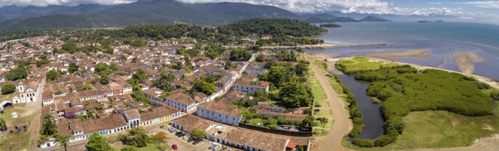 Panoramic aerial view to historic town Paraty with green mountains and sea in background on a sunny