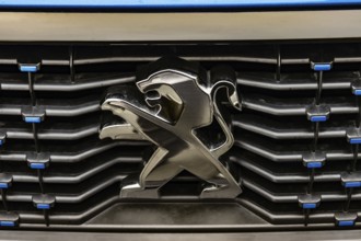WETZLAR, Germany 2022-04-23: Peugeot logo closeup on a car grill. Peugeot as car manufacturer was