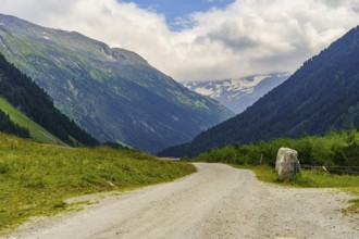 Road through a wide valley surrounded by high mountains, Mittersell, Hohe Tauern, Alps, Austria,