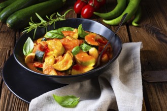 Vegetarian courgette ratatouille with tomato sauce and herbs