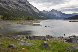 Shallow lake in mountains of Canada and reflection of clouds