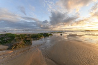Sunset at the atlantic Ocean with orange beach and sky in France