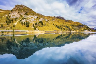Mountain Lake Lago di Fedaia. The magic and harmony of the Dolomites. Glacial lake with cold water.
