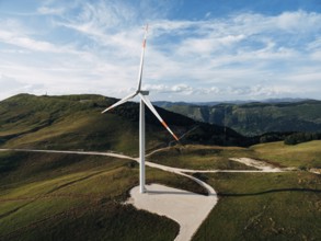 Beautiful bright photo of the wind generator in the field with the road.