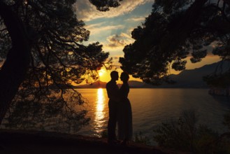 Kotor, Montenegro - 21.06.17: Man and woman stand holding hands on the seashore against the