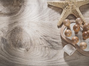 Starfish massager on wooden board copy space spa concept