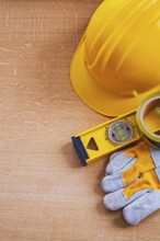 Vintage wood board with safety tools and construction level maintenance concept