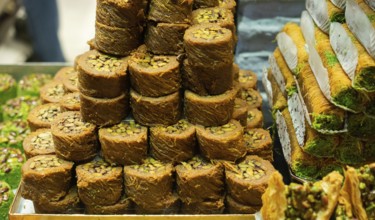 Turkish traditional dessert Kadayif baked in syrup served with nut powder