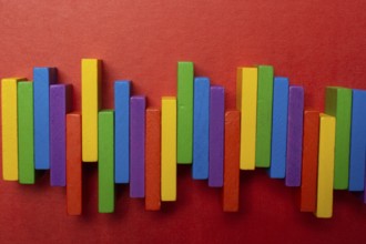 Colorful dominoes. Rainbow colored chain reaction