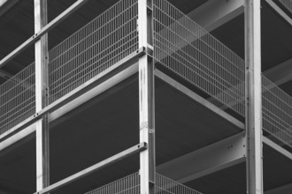 Architectural detail of a modern building highlighting steel beams and metal grids, creating a
