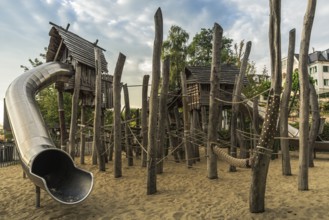 Children's playground with wooden huts, climbing equipment and slide, Bodman-Ludwigshafen,