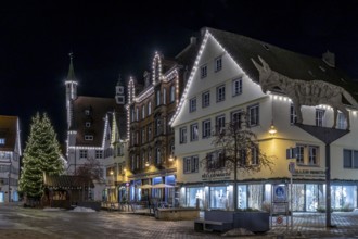 Night shot of historic buildings around the market square with Christmas tree, Biberach donkey, new
