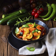 Vegetarian courgette ratatouille with tomato sauce and herbs