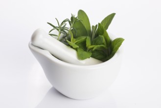 Mortar with herbs isolated on a white background