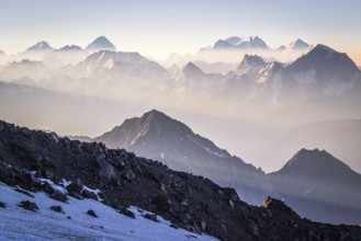 Sunrise in mountains enveloped by sun rays and mist