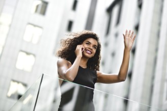Happy smiling afroamerican woman have a nice conversation at street