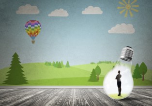 Businesswoman inside light bulb in room against nature drawn concept