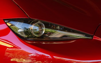 Modern headlight of a red sports car, Genthin, Saxony-Anhalt, Germany, Europe