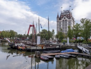 The old harbour Oudehaven with old ships and the historic skyscraper White House (Witte Huis) in