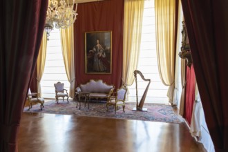 Venaria Reale, Italy, February 2023: luxury interior, old Royal Palace. Perspective with harp,