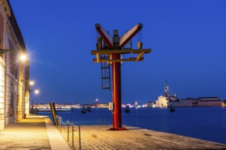 Loading crane on the quay, backlit church of San Giorgio Maggiore, blue hour, Venice, UNESCO World